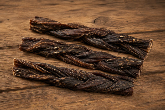 Pets Elite Beef Biltong Twists Dog Treats, on a wooden surface
